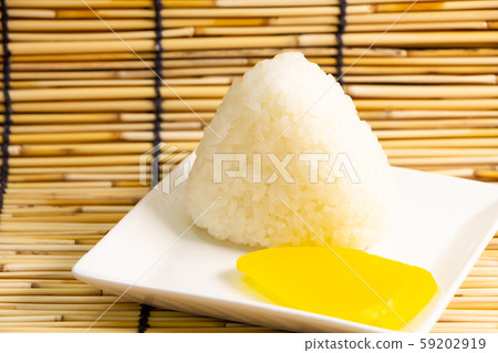 Onigiri (triangle salt musubi) and pickles (takuan pickles). 59202919