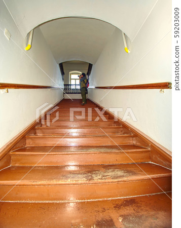 Wooden stairs with handrail in attic in a 59203009