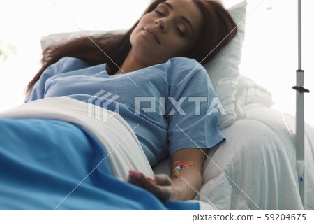 Hand of a young woman with a dropper in ward Hand of a young woman with a dropper in ward 59204675