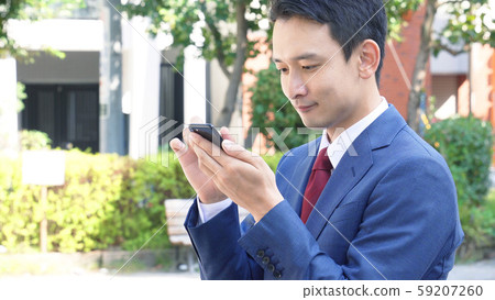 Businessmen using smartphones 59207260
