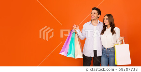 Seasonal shopping. Young couple with colorful shopping bags Seasonal shopping. Young couple with colorful shopping bags 59207738