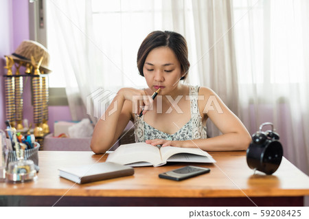 Asian female student read book for final exam Asian female student read book for final exam 59208425