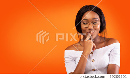 Afro Girl Thinking About Something Standing Over Orange Background, Panorama Afro Girl Thinking About Something Standing Over Orange Background, Panorama 59209301