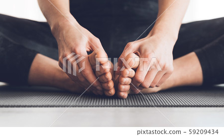 Woman sitting in lotus position with bare feet 59209434