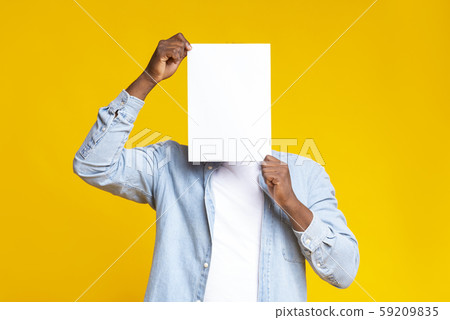 Black guy covering his face with white blank paper 59209835