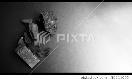 Close-up images of black color charcoal on black background that made from natural wood which represent energy power concept or healthy or use for absorb odor in the room or refrigerator. Close-up images of black color charcoal on black background that made from natural wood which represent energy power concept or healthy or use for absorb odor in the room or refrigerator. 59211005