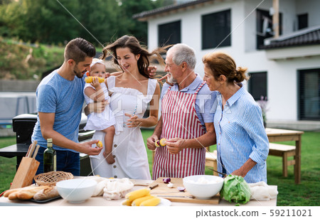 Portrait of multigeneration family outdoors on garden barbecue. 59211021