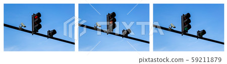 Set of red, yellow and green traffic lights and outdoor surveillance camera above a roadway 59211879
