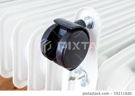 Close-up of a plastic twin wheel on an electric oil heater Close-up of a plastic twin wheel on an electric oil heater 59211880