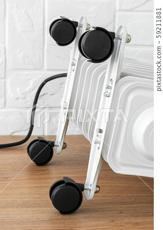Four plastic twin wheels just installed on an electric oil heater. Four plastic twin wheels just installed on an electric oil heater. 59211881
