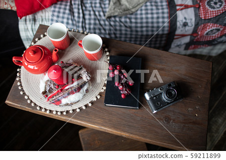 Retro camera is on the table on the background of Christmas songs and Christmas trees Retro camera is on the table on the background of Christmas songs and Christmas trees 59211899