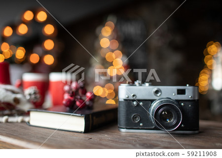 Retro camera is on the table on the background of Christmas songs and Christmas trees 59211908