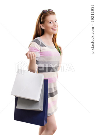 Beautiful young girl with shopping bags 59211955