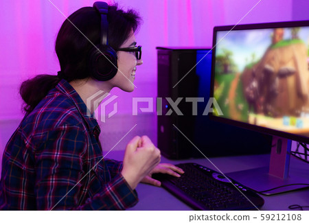 Excited gamer girl rejoicing, winning in video game 59212108