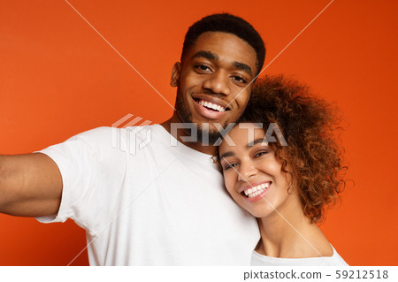 Happy african couple in love taking selfie together 59212518