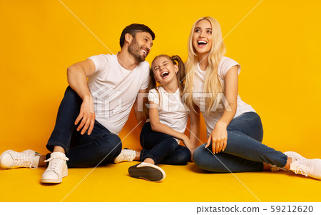 Parents And Daughter Laughing Sitting On Floor In Studio 59212620