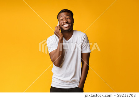 African American Man Laughing Looking At Camera Over Yellow Background 59212708