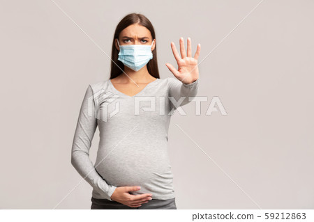 Pregnant Woman In Medical Face Mask Gesturing Stop, Gray Background Pregnant Woman In Medical Face Mask Gesturing Stop, Gray Background 59212863