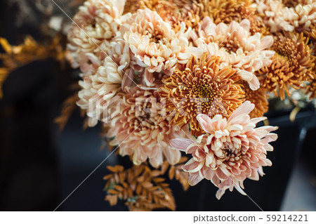 Beautiful autumn bouquet of mixed flowers with peonies. The work of the florist. Flower delivery 59214221