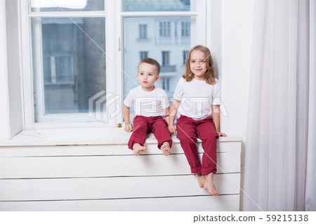 boy with girl brother and sister sitting together in a room boy with girl brother and sister sitting together in a room 59215138
