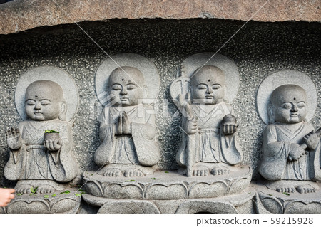 Buddhist sculptures carved on a temple wall  in 59215928