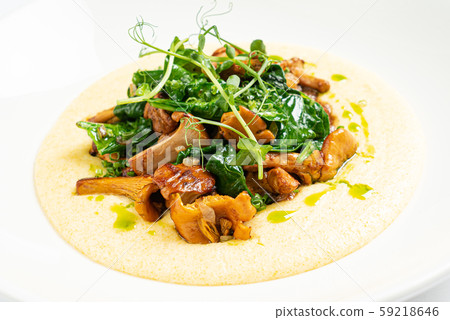 polenta with chanterelles on the white plate 59218646