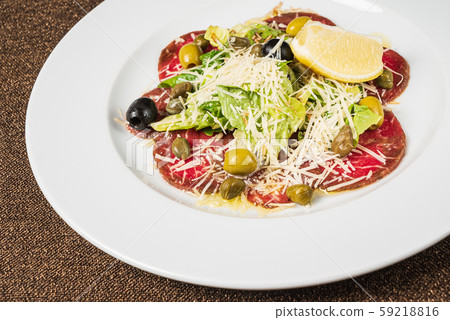 beef carpaccio with parmesan and lemon 59218816