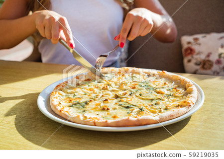 woman eating pizza in the cafe woman eating pizza in the cafe 59219035