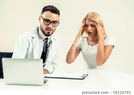 Male Doctor and Female Patient in Hospital Office Male Doctor and Female Patient in Hospital Office 59220791
