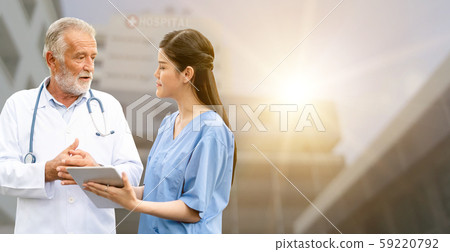 Senior and young doctor working in the hospital. Senior and young doctor working in the hospital. 59220792