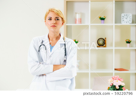 Young female doctor working in hospital office. Young female doctor working in hospital office. 59220796