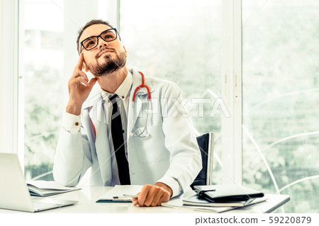 Doctor thinking while working in hospital. 59220879