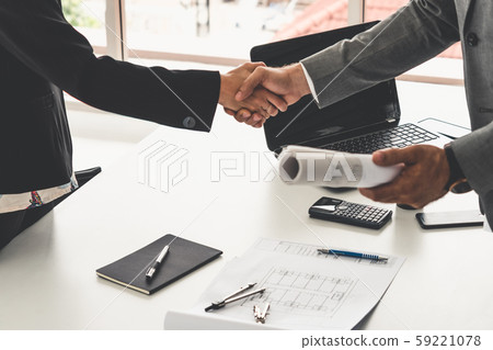 Businessman handshake businesswoman in office. Businessman handshake businesswoman in office. 59221078