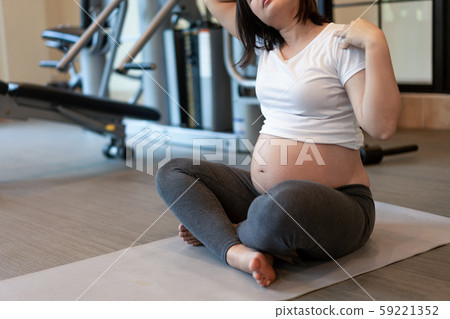 Active pregnant woman exercise in fitness center. 59221352
