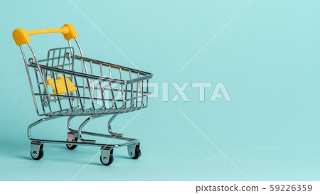 Shopping cart staggered on blue, copy space Shopping cart staggered on blue, copy space 59226359