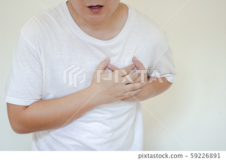 Sick man having painful Chest having heart attack at home,Hands squeezing Chest.healthcare concept Sick man having painful Chest having heart attack at home,Hands squeezing Chest.healthcare concept 59226891