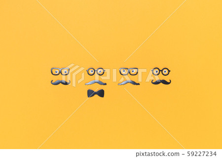 Four faces with mustaches for Movember on yellow 59227234