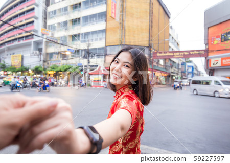 Beautiful women in Chinese suit leading man hand Beautiful women in Chinese suit leading man hand 59227597