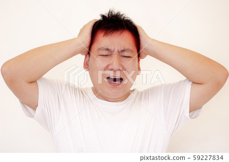 Young man is suffering from a headache,Concept healthcare and medical. Young man is suffering from a headache,Concept healthcare and medical. 59227834