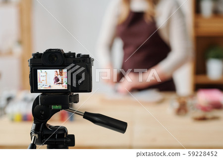Creative woman in home camera recording soap making master class for subscribers 59228452