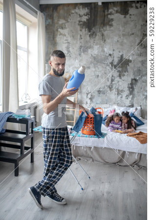 Father feeling busy with laundry at the weekend 59229238