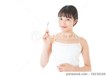 Young woman brushing her teeth Young woman brushing her teeth 59230108