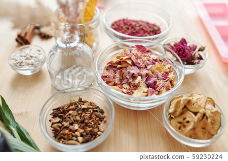 Group of glassware with dry aromatic ingredients and spices on wooden table Group of glassware with dry aromatic ingredients and spices on wooden table 59230224