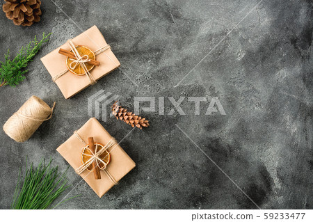 Christmas gifts, winter plants and cones on dark background. Winter composition. Flat lay. Top view Christmas gifts, winter plants and cones on dark background. Winter composition. Flat lay. Top view 59233477