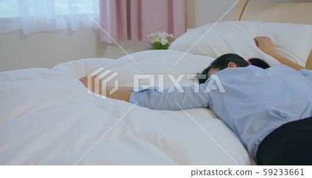 businesswoman feel tired on bed 59233661