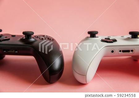 White and black two joystick on pink background. White and black two joystick on pink background. 59234558