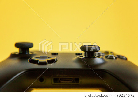 Black joystick on yellow background. Computer 59234572