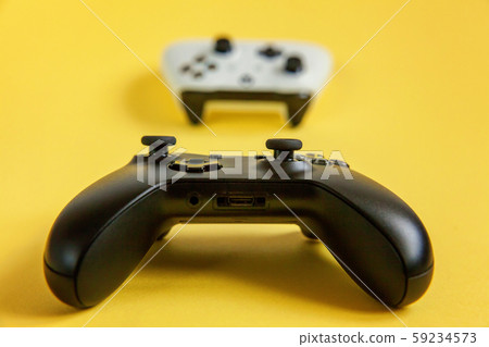 White and black two joystick on yellow background. White and black two joystick on yellow background. 59234573