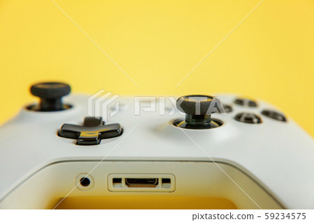 White joystick on yellow background. Computer White joystick on yellow background. Computer 59234575