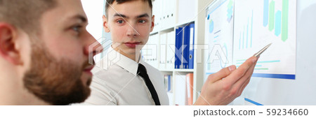 Smart colleagues looking at board Smart colleagues looking at board 59234660